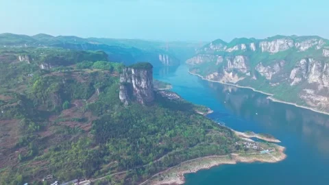 A hundred-meter cliff flanked by a green river Stock Footage 311537735