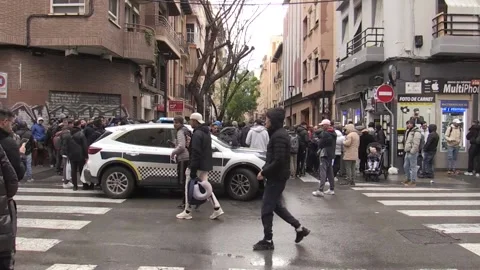 Hundreds of Algerians queue at consulate in Alicante amid Spain regularisation p Stock Footage 328237946