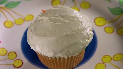 Hundreds and thousands being sprinkled on cupcake in slow motion Stock Footage 71210503