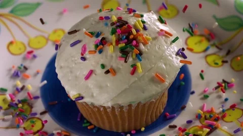 Hundreds and thousands falling on cupcake in slow motion Stock Footage 71210734