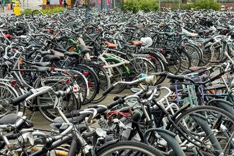 Hundreds of bicycles sit lined up in Eindhoven parking lot Stock Photos