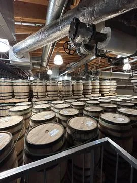 Hundreds of Bourbon Whiskey Barrels Stacked High for Slow Aging. Stock Photos