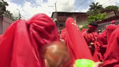Hundreds of "dancing devils" celebrate Corpus Christi with procession in Venezue Video stock 243322602