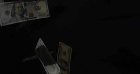 Hundreds Isolated On Black falling through the air Stock Footage 64939355