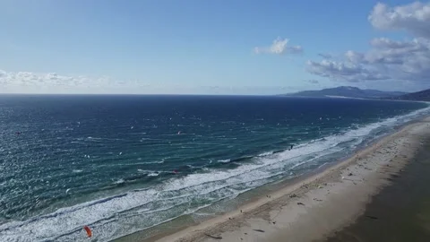 Hundreds of kiters on the ocean beach in Tarifa Stock Footage 231472683