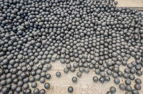 Hundreds or thousands of black rubber balls laying on the stone stairs in street Stock Photos