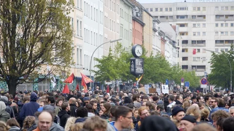 Hundreds of people protest demonstration flags, labor day May 1st, Berlin Stock Footage 90032723