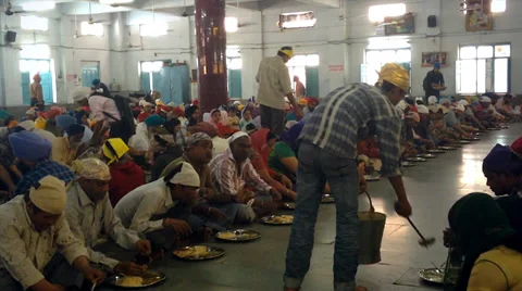 Hundreds of Sikhs are provided with meals near a holy site in Old Delhi, India. Stock Footage 37520002