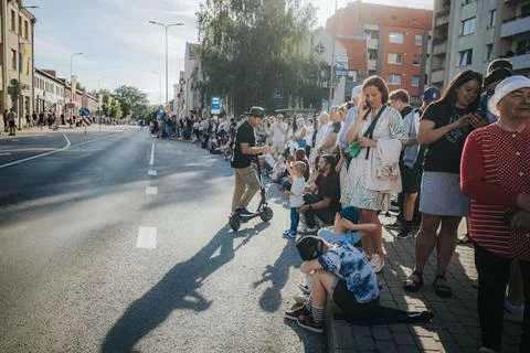 Hundreds of soap bubbles drift across a wide city street. Stock Photos