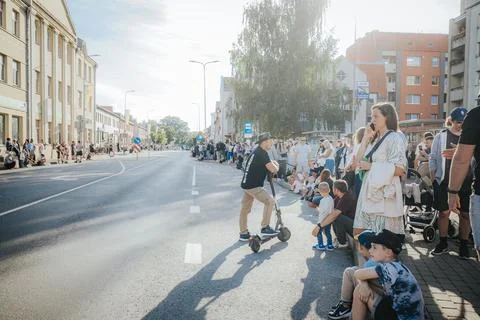 Hundreds of soap bubbles drift across a wide city street. Stock Photos
