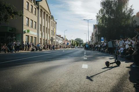 Hundreds of soap bubbles drift across a wide city street. Stock Photos