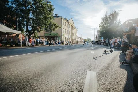 Hundreds of soap bubbles drift across a wide city street. Stock Photos