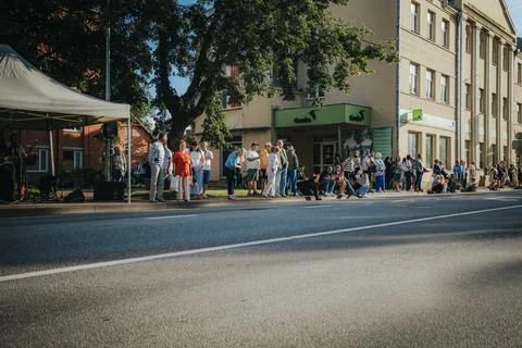 Hundreds of soap bubbles drift across a wide city street. Stock Photos