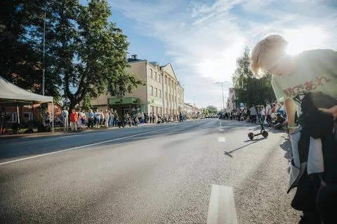 Hundreds of soap bubbles drift across a wide city street. Stock Photos