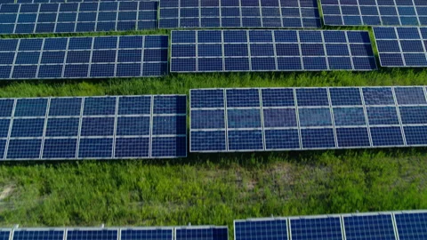 Hundreds of solar panels arranged in rows on wild field Stock Footage 159781573