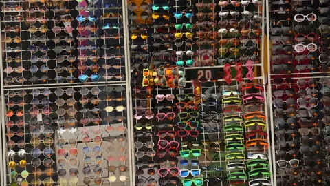 Hundreds of sunglasses on display rack in front of tourist shop. Stock Footage 201291485
