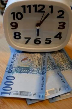 Hungarian 1000 forint notes with clock, time is money concept Photos