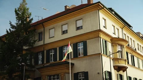 Hungarian flag waves outside a historic building in Belgrade Serbia Stock Footage 346713437