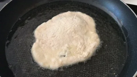 A Hungarian specialty, a deep fried flat bread made of potato-based dough Stock Footage 132585643