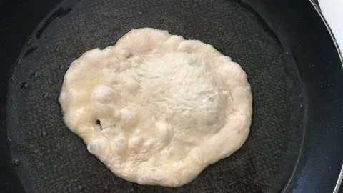A Hungarian specialty, a deep fried flat bread made of potato-based dough Stock Footage 132585647