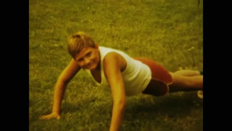 Hungary 1970, Young boy doing push-ups during communist era sports training.. Stock Footage 239319927