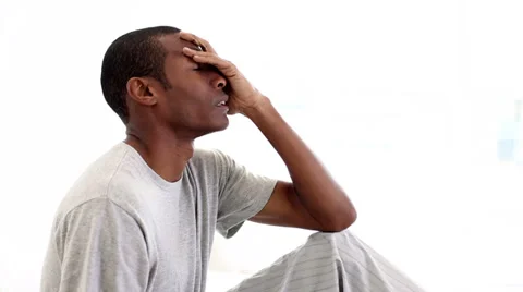 Hungover man sitting on his bed Stock Footage 34663366