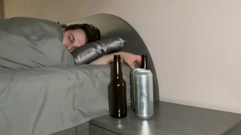 Hungover Person Reaching for Bottle While in Bed Stock-Footage 310511108