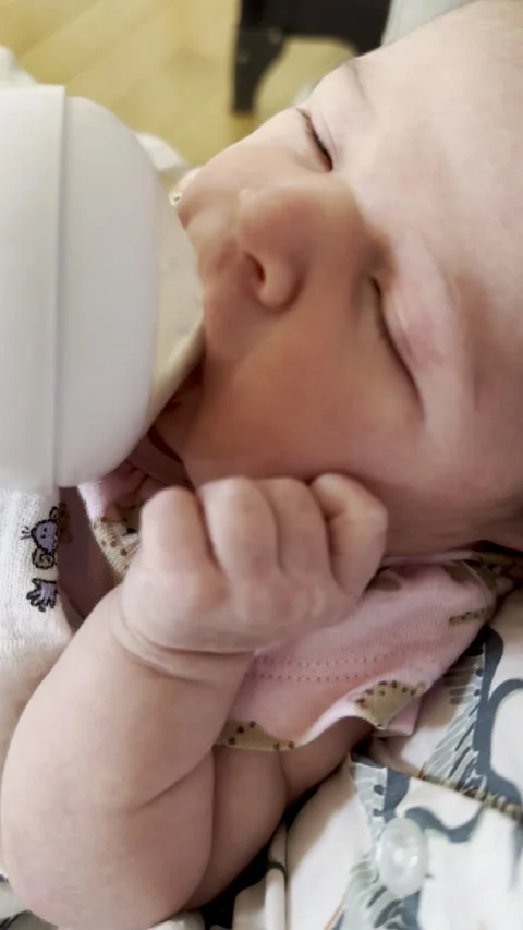 Hungry baby drinking bottle Stock Footage 249575337