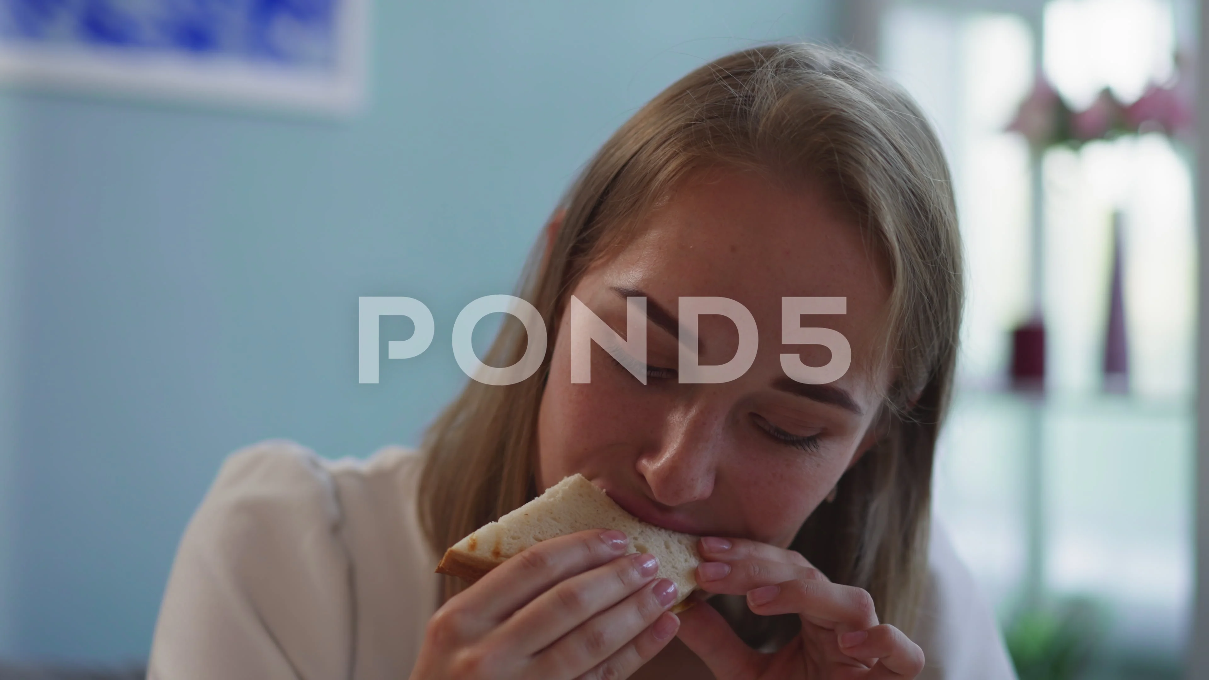 Hungry blonde woman bites delicious sand... | Stock Video | Pond5
