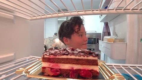 Hungry boy eating cake from Fridge 2 Stock Footage 79681042