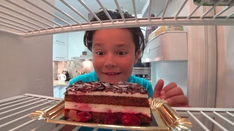 Hungry boy eating cake from Fridge 5 Stock Footage 79681623