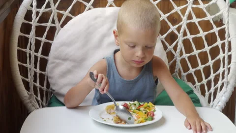 Hungry Boy Eats Healthy Salad and Cutlet on Rustic Porch Stock Footage 322118480