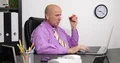 Hungry Businessman in Office Use a Laptop and Eat a Fresh and Sweet Red Apple 4k or 4k+ Resolution