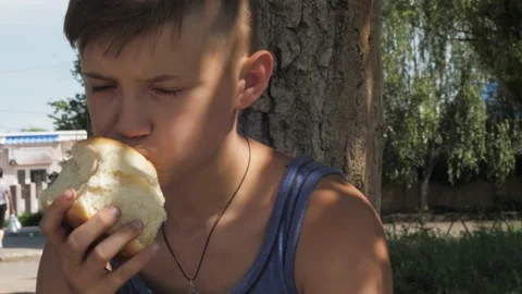 Hungry child eats bread, financial crisis Stock Footage 133651443