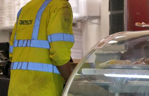 A hungry construction worker with a reflective safety vest getting some lunch Stock Photos