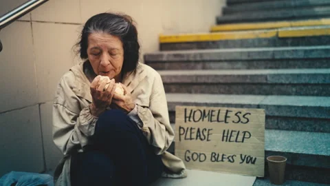 Hungry elderly homeless woman sitting on... | Stock Video | Pond5