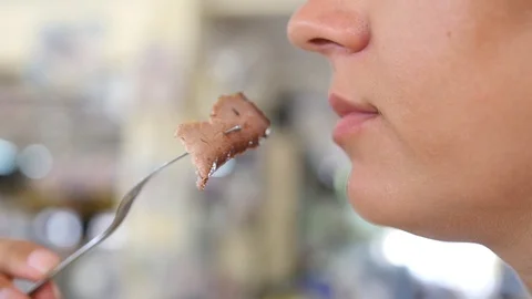 A hungry girl eats a fork with fork, close-up in profile. HD, 1920x1080, slow Stock Footage 91869457