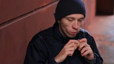 Hungry guy eating bread Stock Footage 97220308