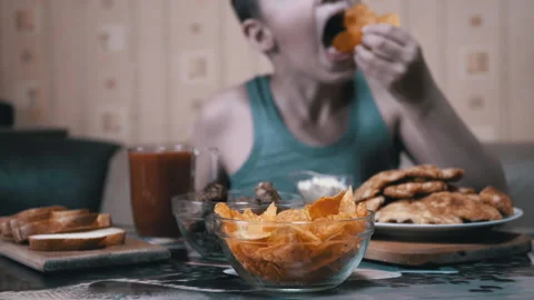 Hungry Kid Hand Takes Crispy Golden Potato Chips from Plate. Junk Food in Dinner 動画素材 142523340