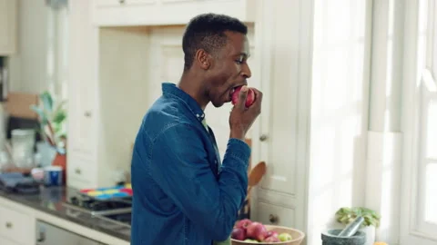 Hungry, man and apple in kitchen with healthy snack, antioxidants and vitamins Stock Footage 335802085