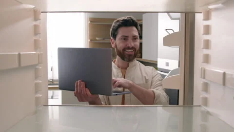 Hungry man guy open empty refrigerator confused find problem solution idea order Stock Footage 245832164