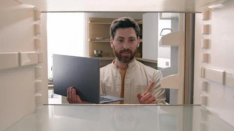 Hungry man guy open empty refrigerator confused find problem solution idea order Stock Photos