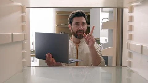 Hungry man guy open empty refrigerator confused find problem solution idea order Stock Photos