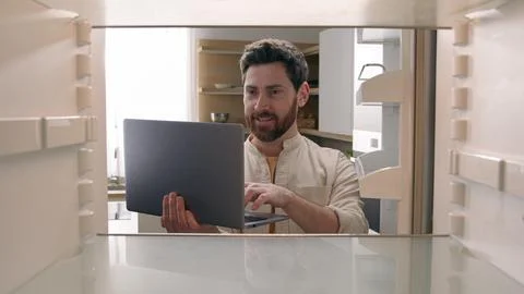 Hungry man guy open empty refrigerator confused find problem solution idea order Stock Photos