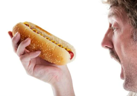 Hungry man with hot dog Stock Photos