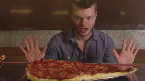 Hungry man looking at pizza - 4K Stock Footage 67341277