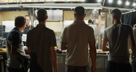 Hungry people in queue for take out food in street festival Stock Footage 121286996
