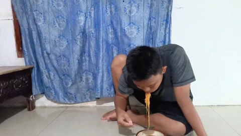 Hungry young Asian man. Stock Footage 321930795