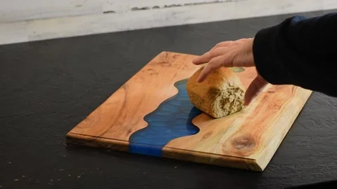 A hunk of homemade bread being cut in half Stock Footage 165370540