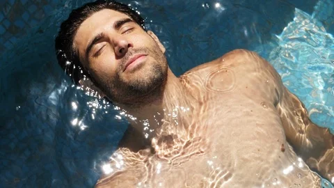 Hunk relaxing in pool Stock Footage 89463764